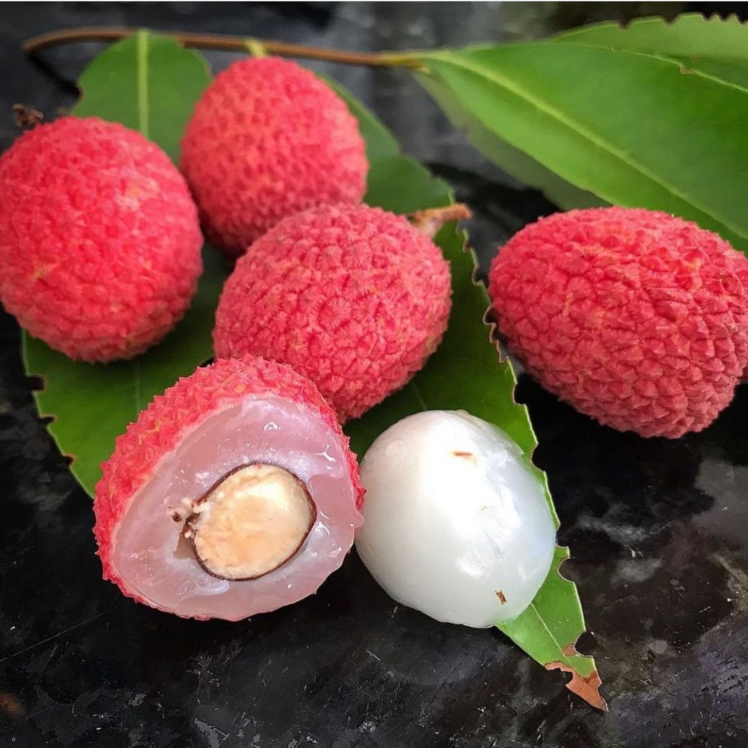 A cluster of lychees, each with a white seed inside. A delicious and exotic fruit known as lychee.

