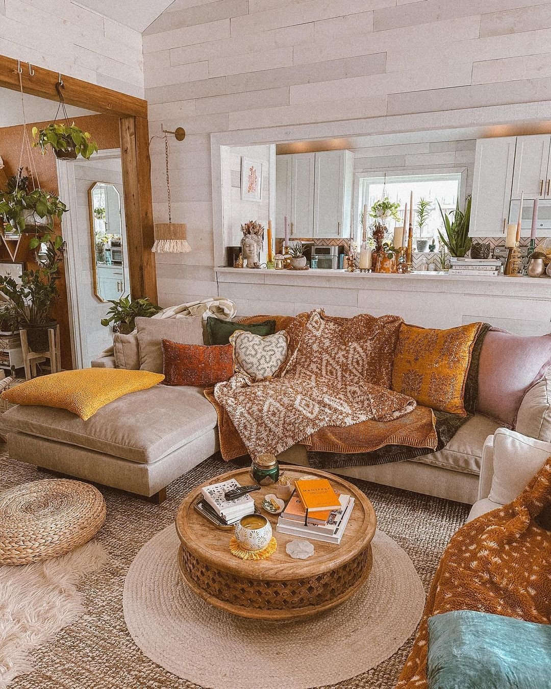 A potted plant on a shelf in an outdoor living room with a kitchen.