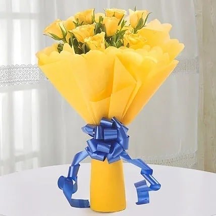 A vibrant bouquet of yellow roses elegantly tied with a blue ribbon, symbolizing friendship and joy in Western culture.